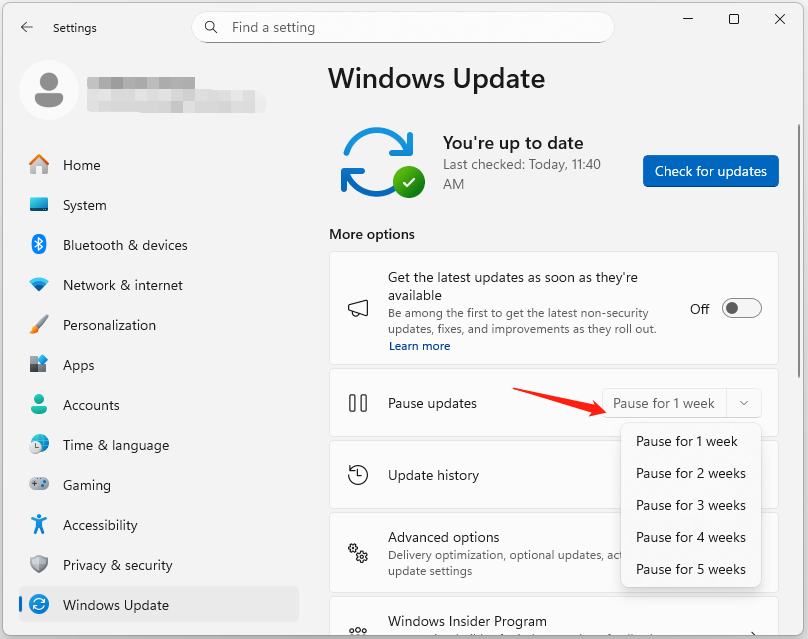 The Windows Update page with expanded Pause updates menu and pointed arrow.