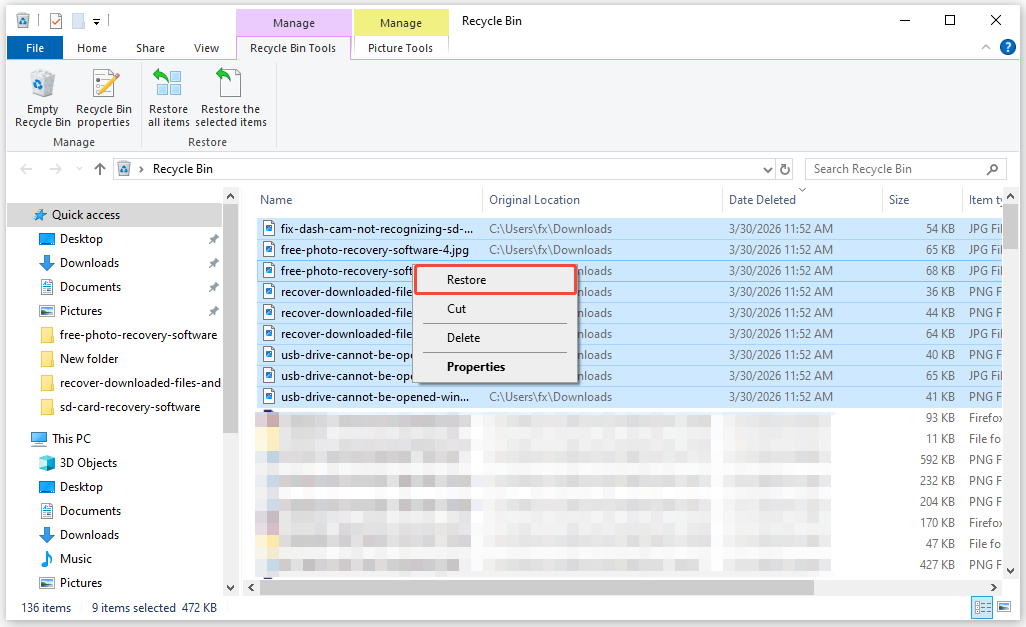 The Recycle Bin interface showing the deleted downloads files, with the Restore option highlighted.