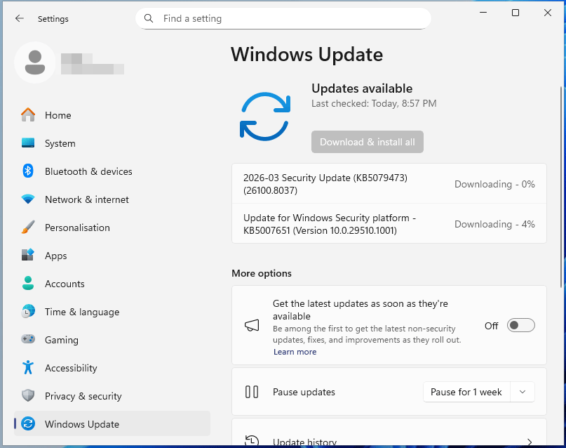 The Windows Update window in Settings showing the update downloading process.