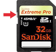 A 32 GB SanDisk SD card with a red arrow pointing to the physical write-protection switch.