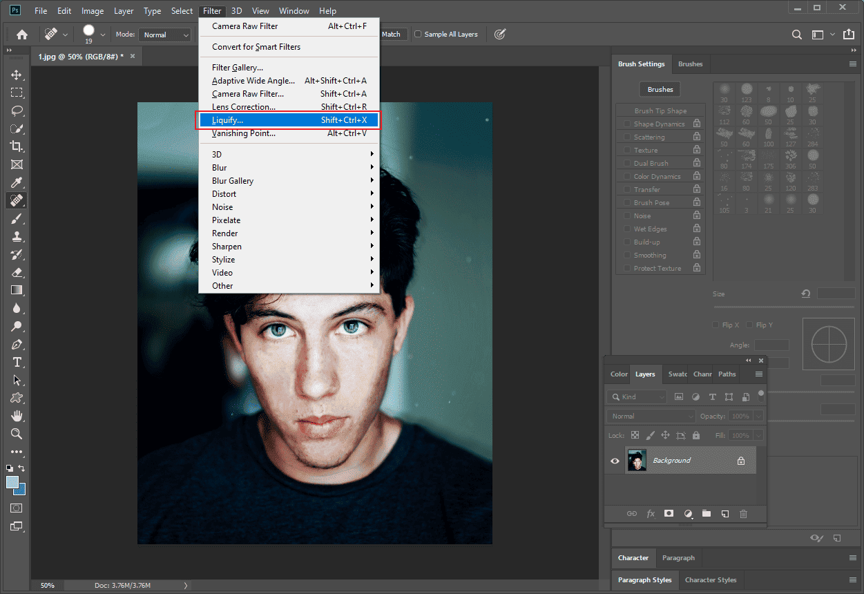 Photoshop interface with the Liquify…option selected from the Filter tab.
