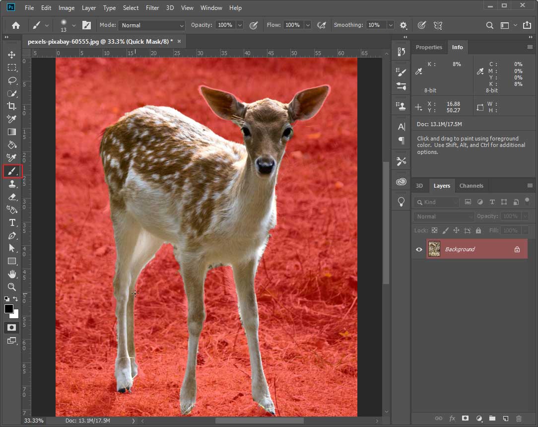 Photoshop interface with a deer on a red background and the selected brush tool on the left side.