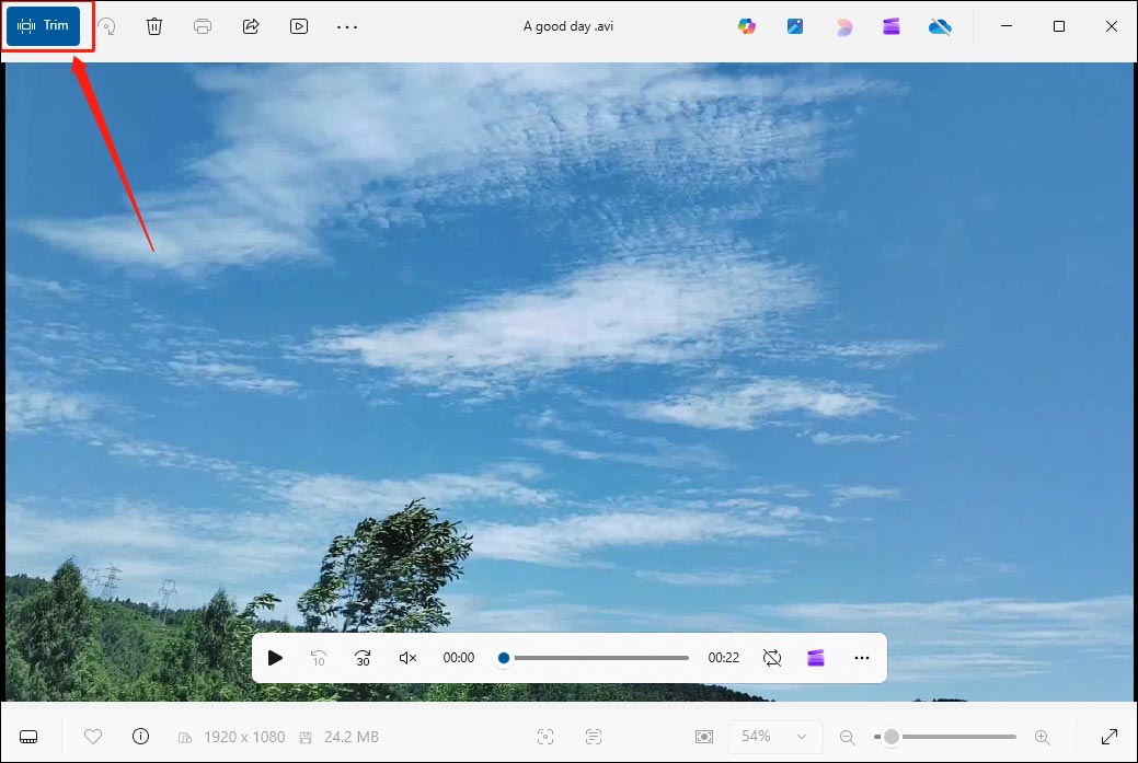 The Windows Photos video player highlighting the Trim option in the top left corner.