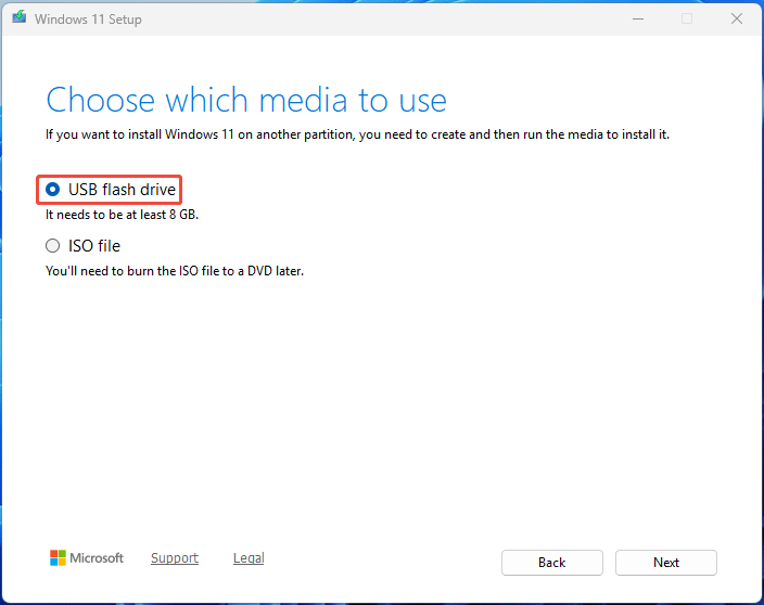 The Windows 11 Setup interface with the selected USB flash drive option in the media choosing step.