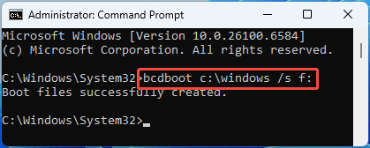 Command Prompt window showing the bcdboot command to write boot files to a partition.