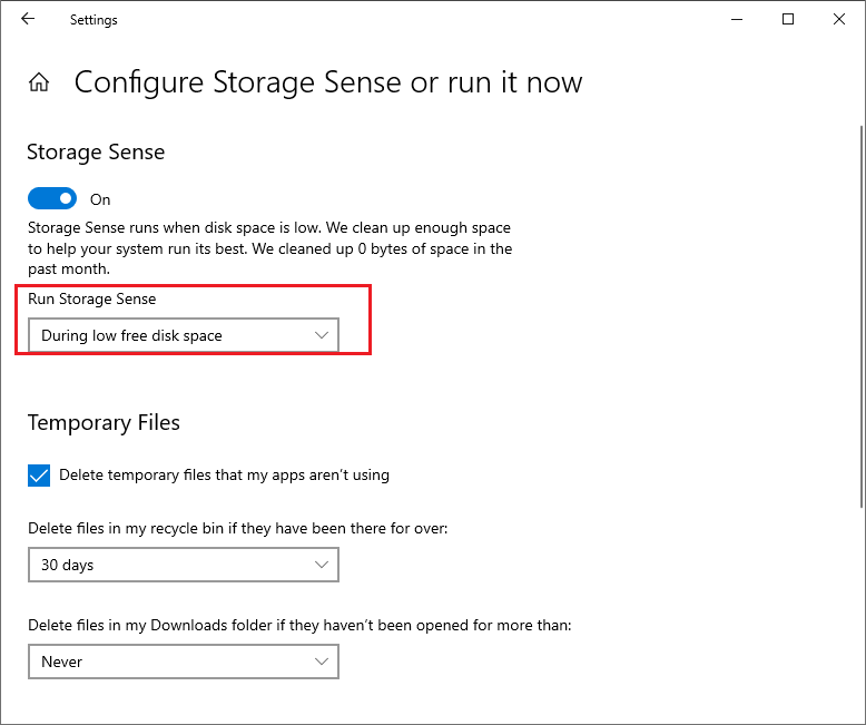 Windows Configure Storage Sense or run it now settings page with the Run Storage Sense set to During low free disk space.